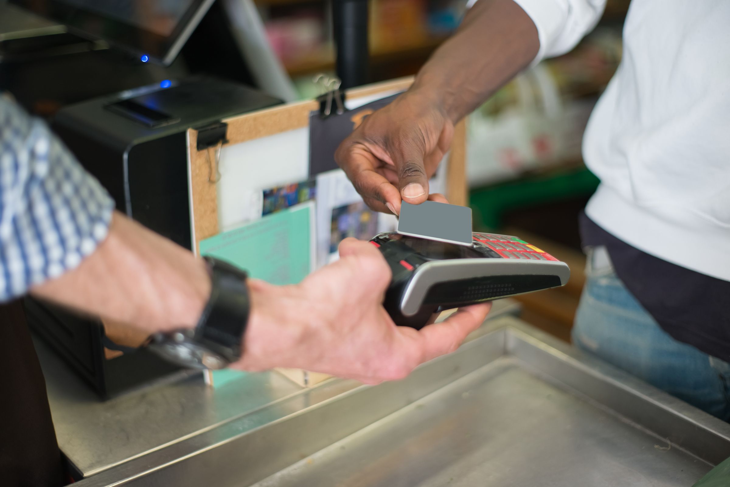 Customer tapping a card on a payment terminal